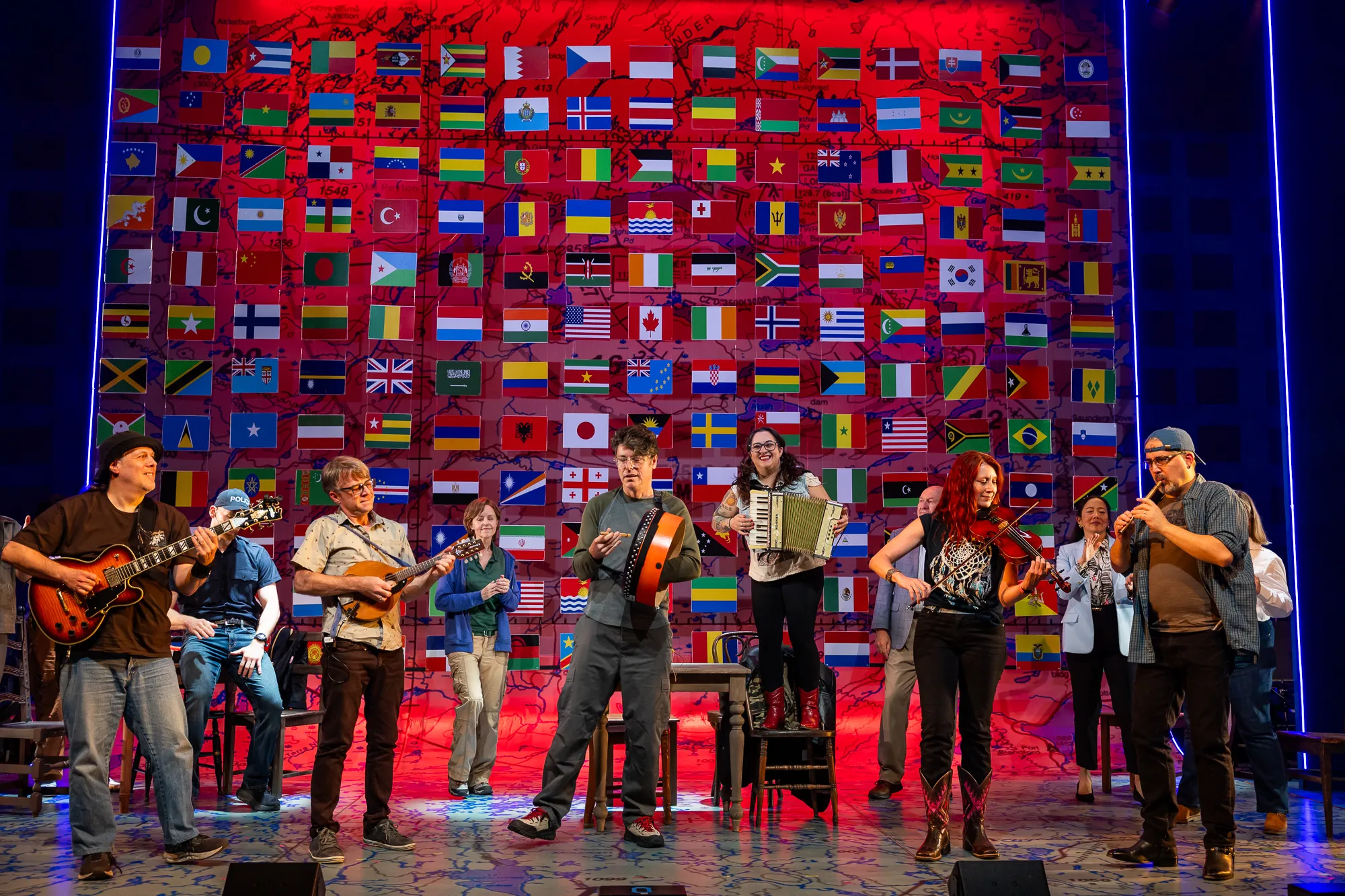 Brian O'Neill playing bodhran on stage during the Come From Away finale
