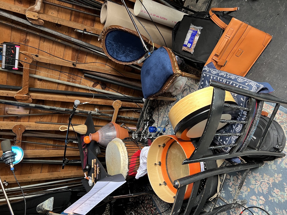 Come From Away percussion station: two bodhr&aacute;ns, djembe, udu, shaker and tippers laid out on a trap table backstage